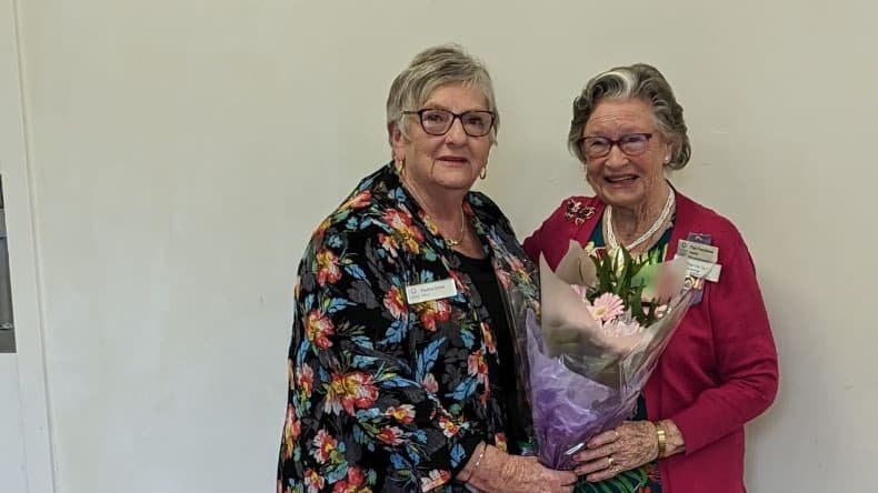 pauline presents patricia with 30 year badge 2023